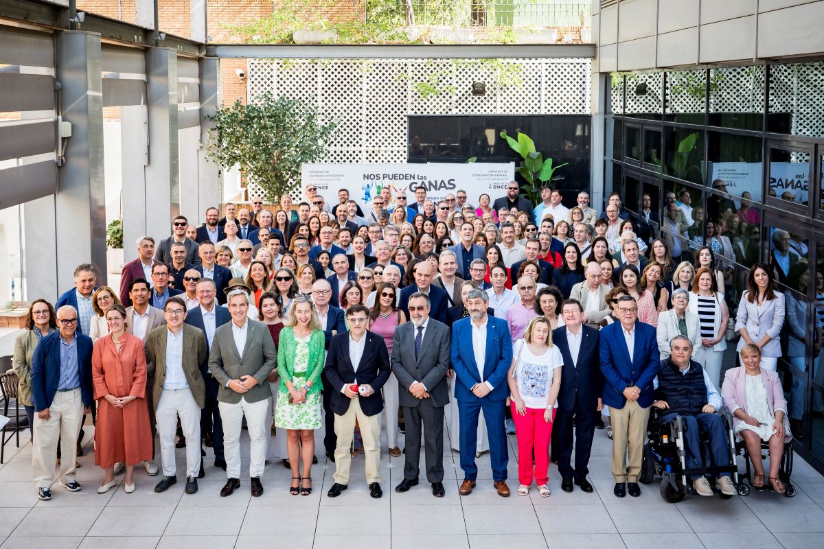 Foto de familia del grupo de asistentes presenciales a las JCG en el patio del Hotel Ilunion Pio XII, con los máximos responsables en primera fila
