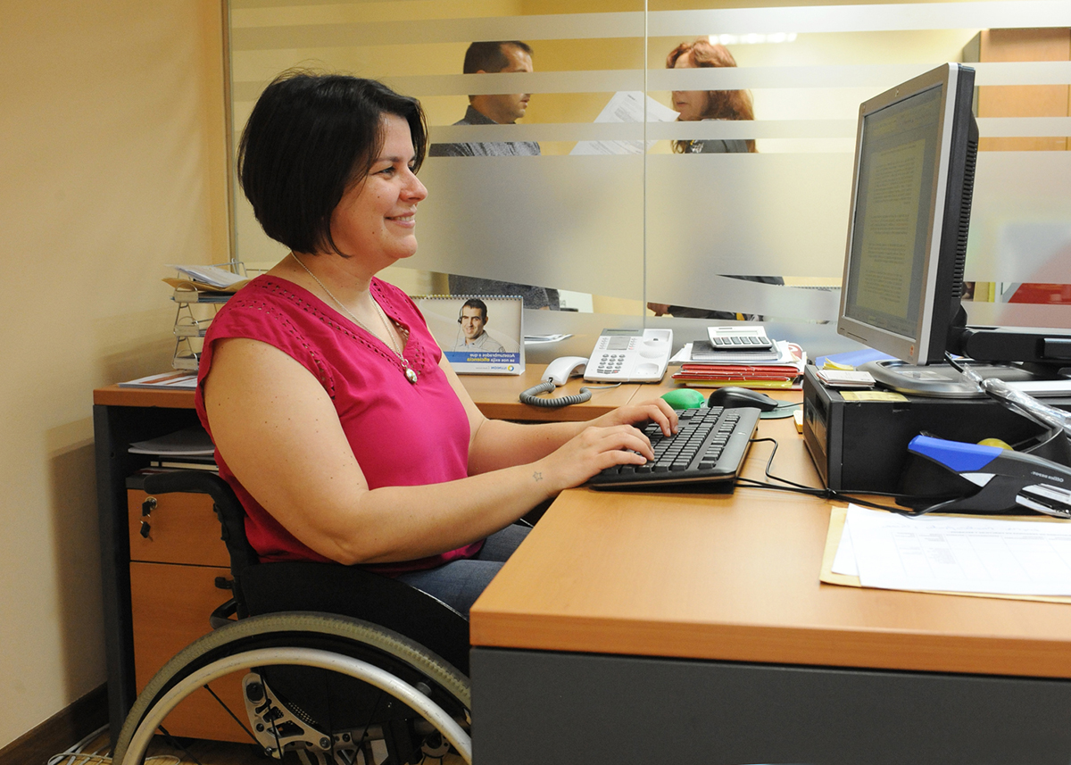 Trabajadora en silla de ruedas en su mesa