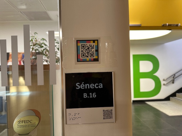 Detalle de la entrada del aula Séneca en el CRE de Madrid, donde hay colocado encima del cartel del aula un código QR Navilens.