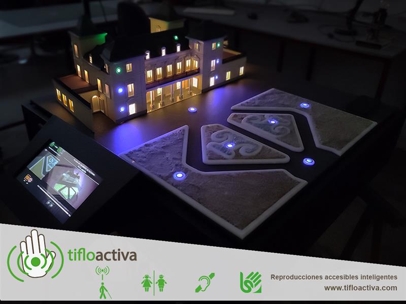 Maqueta en 3D del Palacio de los Duques de Pastrana, con edificio y jardines iluminados y pantalla con información