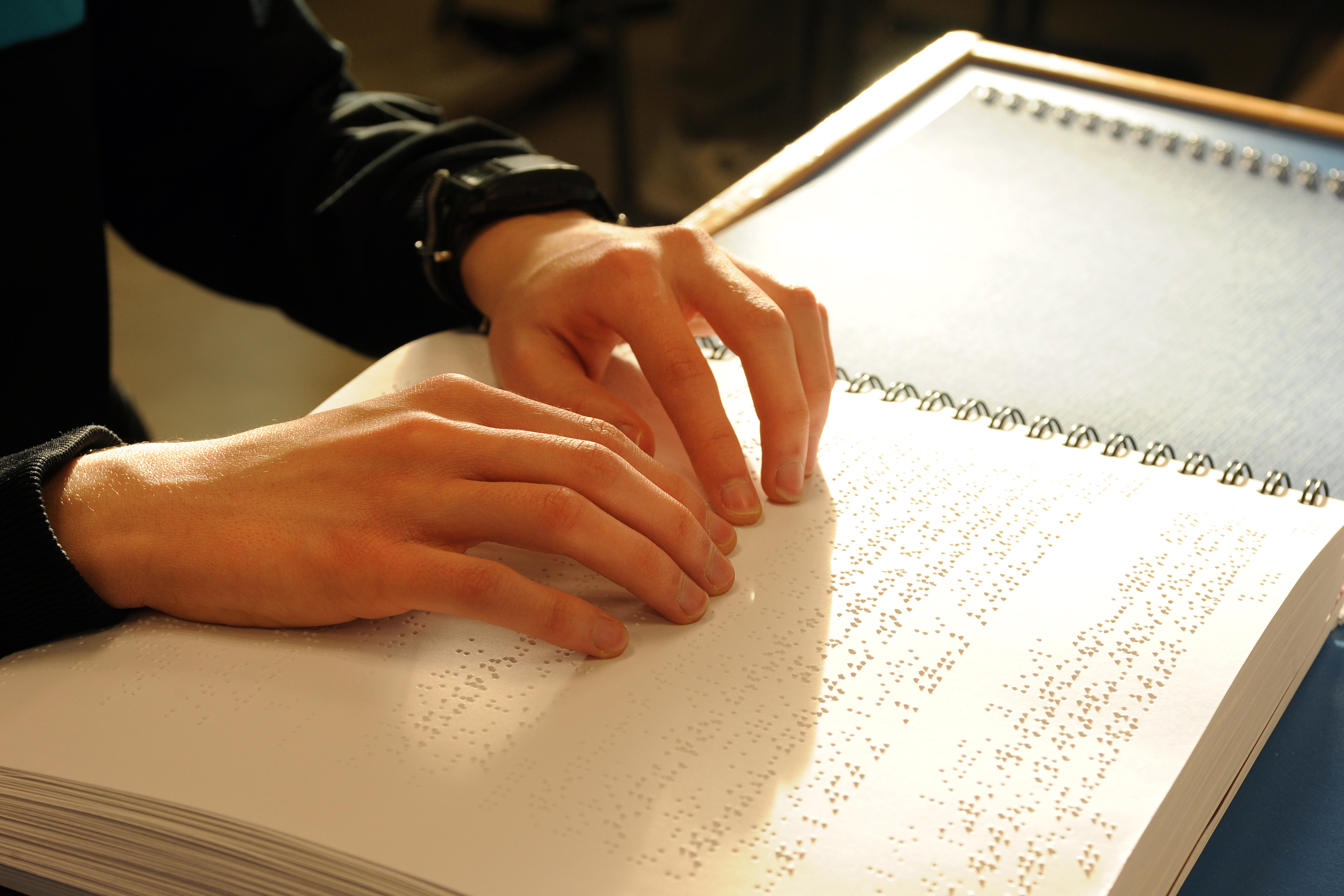 Manos leyendo un texto en braille